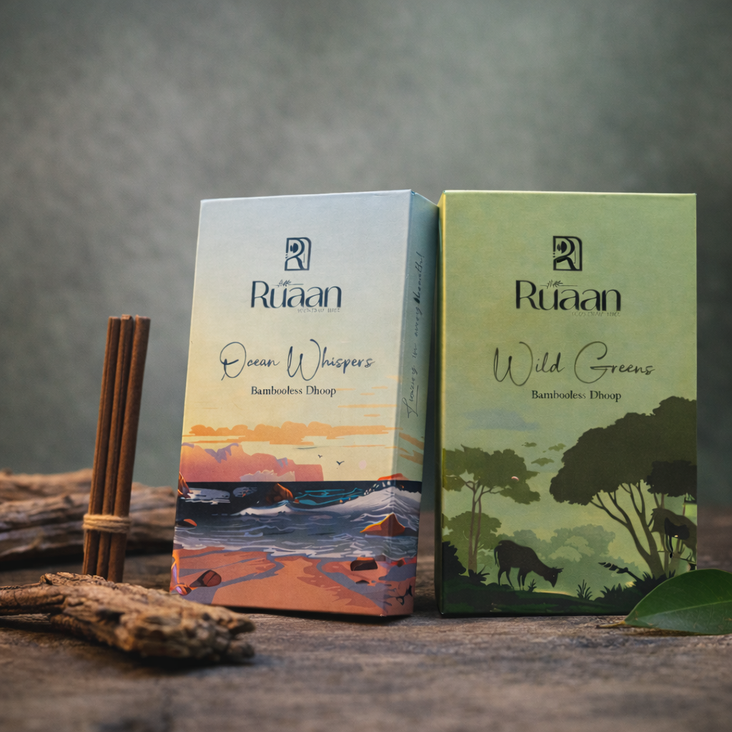 Two Ruaan product boxes, one titled 'Ocean Whispers' and the other 'Wild Greens', on a wooden surface with natural elements.