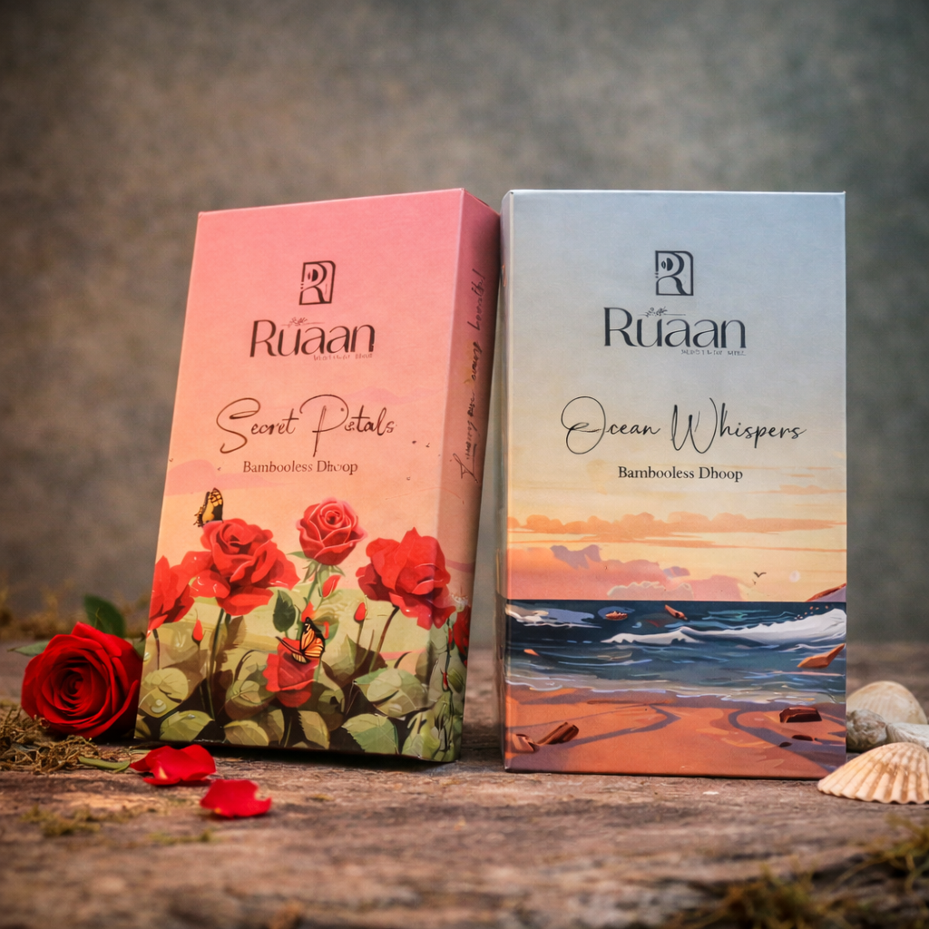 Two Ruaan product boxes, one with roses and the other with a beach scene, on a wooden surface.